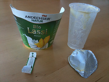 Yogurt cup after being split into parts.
